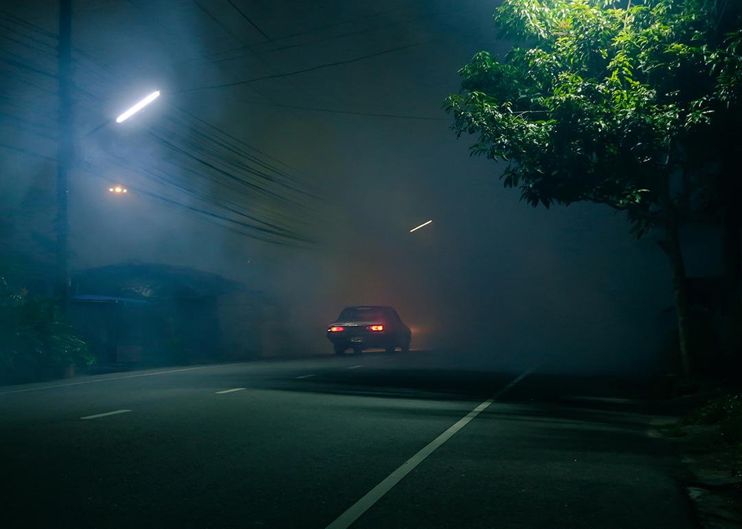 Car driving on a dark street on Halloween